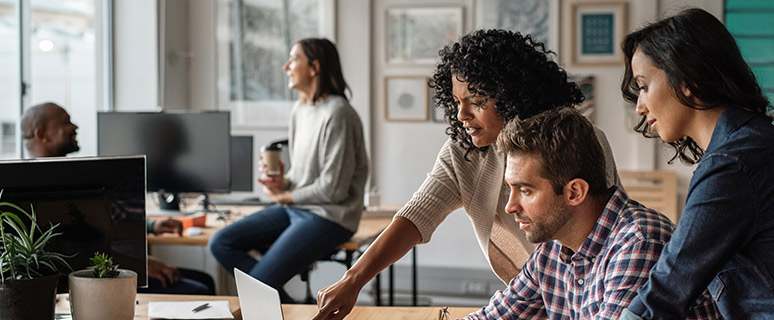 a photo of people looking at computer