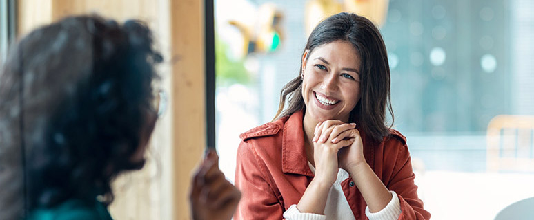 A photo of a woman laughing with another woman