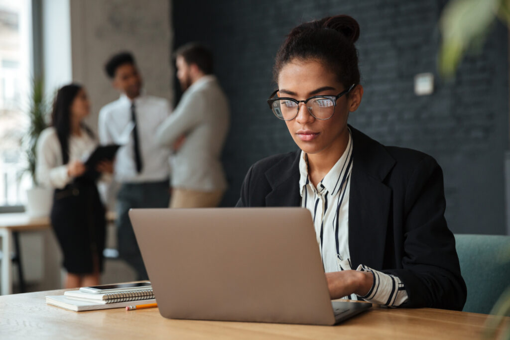 Woman using vector search on laptop in office